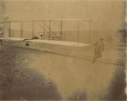 Dan Tate and the Wright brothers launching the Wright glider, Outer Banks, North Carolina, 1903 Photograph